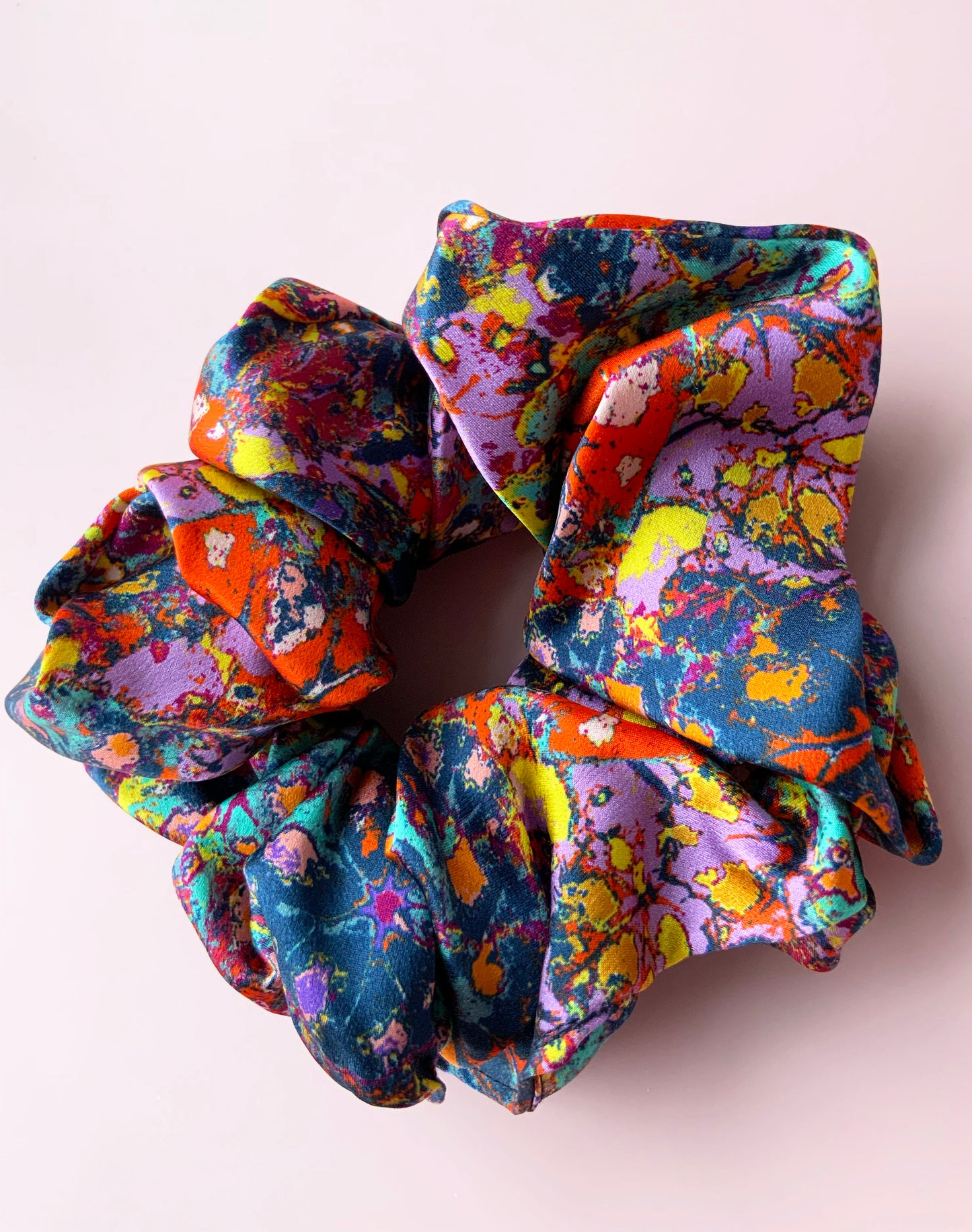 LANYA_TROPICANA_FROOTI_REEF_SILK_SCRUNCHIE_UPCLOSE_PINK_BACKGROUND
